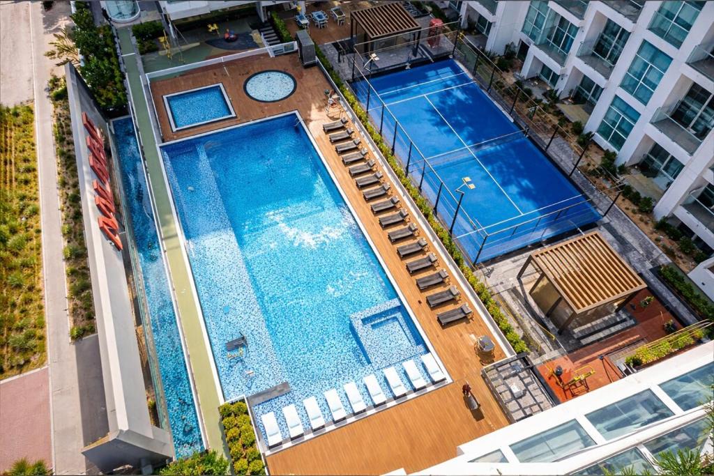 Discovery Gardens Apartment | Vogue Vacation Homes, Al Furjan Pearlz by Danube near Ibn Battuta Mall, One Bedroom Apartment with Balcony and vibrant community view, Access to all Amenities, Walkable to Al Furjan Metro Station