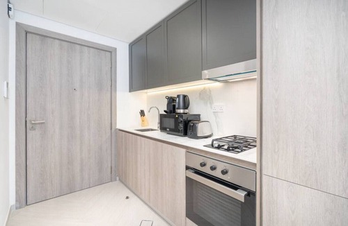Jumeirah Village Circle Apartment | Relax & Recharge Studio Loft with hanging net